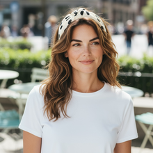 Load image into Gallery viewer, Woman wearing a white t-shirt and patterned headband outdoors