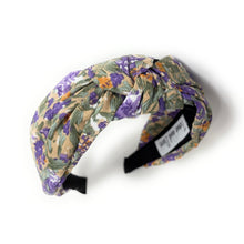 Load image into Gallery viewer, Floral headband featuring a twisted design with purple, green, and beige hues. The soft fabric and intricate pattern convey an elegant, feminine tone.