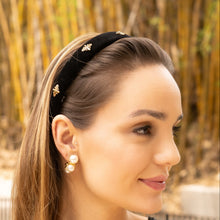 Load image into Gallery viewer, Woman wearing black velvet bee headband with pearl earrings outdoors.