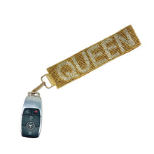 Load image into Gallery viewer, Keychain with 'QUEEN' strap attached to a car key fob on a white background