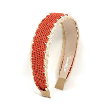 Load image into Gallery viewer, A woven open cuff headband in terracotta red and cream, featuring a beige interior lining with a visible 'Tweedle' brand logo and a gold-toned metal tip.