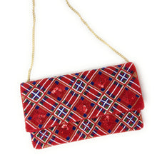 Load image into Gallery viewer, Red patterned clutch bag with a gold chain on a white background
