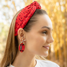 Load image into Gallery viewer, Woman wearing a red headband and earrings with a blurred autumn background