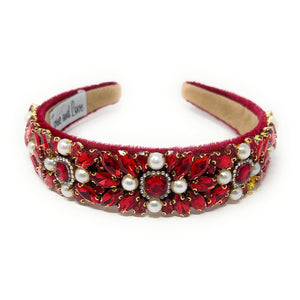 Elegant red headband adorned with intricate red crystals, pearls, and gold accents, conveying a luxurious and sophisticated tone.