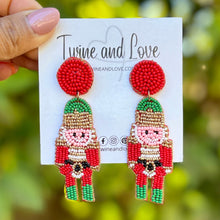 Load image into Gallery viewer, red Nutcracker Beaded Earrings, Christmas Earrings, Holiday Earrings, Christmas Beaded Earrings, Seed Bead, Merry Christmas, red green Nutcracker soldier earrings, red beaded earrings, Christmas beaded earrings, red bead earrings, red green holiday earrings, holiday earrings, Nutcracker earrings, red earrings, holiday gifts, holiday accessories, holiday beaded accessories, Holiday nutcracker accessories, Holiday Christmas earrings, Christmas gifts, Best seller, best Selling items, Christmas earrings, Custom