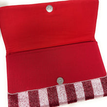 Load image into Gallery viewer, Red pouch with a stripped bottom section on a white background