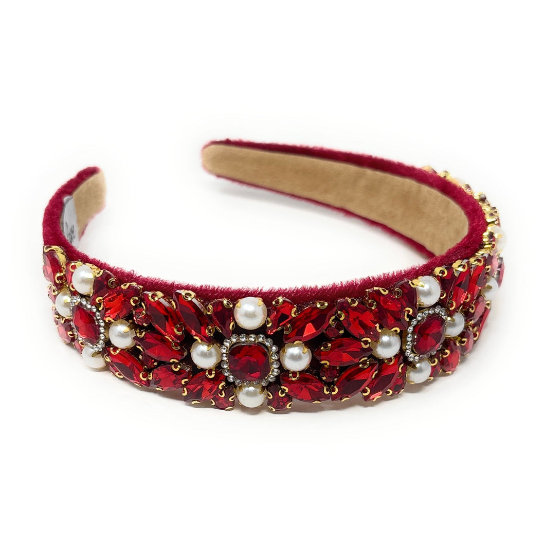 Elegant red headband adorned with intricate red crystals, pearls, and gold accents, conveying a luxurious and sophisticated tone.