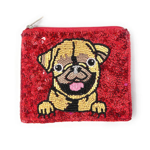 A red sequin pouch features a beaded design of a smiling pug. The dog has its tongue out and front paws visible, adding a playful, cheerful touch.