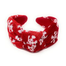 Load image into Gallery viewer, Red velvet headband adorned with white snowflake patterns. The texture is soft and plush, giving a festive, cheerful vibe against a plain white background.