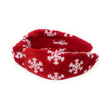 Load image into Gallery viewer, Red velvet headband adorned with white snowflake patterns. The texture is soft and plush, giving a festive, cheerful vibe against a plain white background.