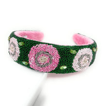 Load image into Gallery viewer, Statement floral headband showcasing detailed rose designs, green leaf accents, and luxurious handcrafted beadwork.