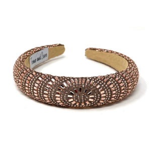 Elegant rose-gold headband adorned with intricate geometric beadwork on a neutral background. The label reads "Time and Love," conveying sophistication.