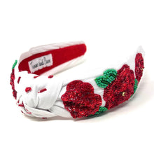 Load image into Gallery viewer, White knot headband with sparkling red sequin roses and green leaf embellishments.