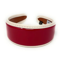 Load image into Gallery viewer, Shiny cherry red padded headband featuring a smooth patent surface and ivory edging.
