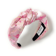 Load image into Gallery viewer, Pink patterned headband with a white pillow on a white background