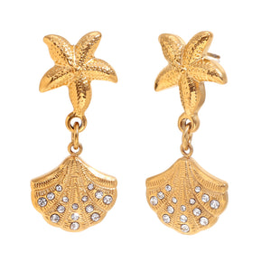 18k Gold Plated earrings feature starfish studs with dangling shell charms adorned with rhinestones, conveying a seaside theme with elegance.