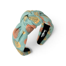 Load image into Gallery viewer, Aqua blue knot headband featuring a colorful seashell pattern in coral, yellow, and teal tones.
