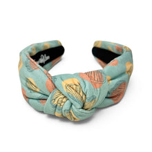 Load image into Gallery viewer, Aqua blue knot headband featuring a colorful seashell pattern in coral, yellow, and teal tones.
