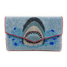 Load image into Gallery viewer, Light blue beaded clutch featuring a bold shark design with ocean-inspired details and handcrafted embellishments.