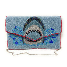 Load image into Gallery viewer, Ocean-themed beaded envelope clutch showcasing a fierce shark motif with sparkling blue and silver bead details.