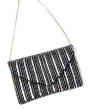 Load image into Gallery viewer, Silver and black sequined clutch with vertical stripes. It features a triangular flap and a silver chain strap, exuding a glamorous, elegant vibe.