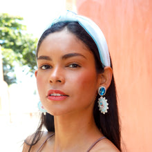 Load image into Gallery viewer, Model wearing a light blue knotted headband and sparkling blue statement earrings outdoors