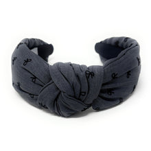 Load image into Gallery viewer, Smokey gray headband with a knotted design, featuring small black bow patterns. The inside tag reads &quot;Time and Love.&quot; The tone is stylish and elegant.