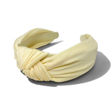 Load image into Gallery viewer, A yellow fabric headband with a knotted twist detail, displayed on a clean white background with a soft shadow.
