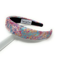 Load image into Gallery viewer, Multicolored headband with a brand label on a white background