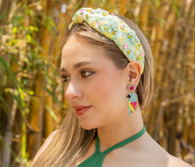 Load image into Gallery viewer, Stylish outdoor look featuring a mint floral knot headband paired with vibrant beaded parrot-inspired drop earrings.