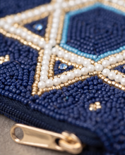 Load image into Gallery viewer, Close-up detail of a navy blue hand-beaded pouch featuring a Star of David design with white pearl and gold beadwork.