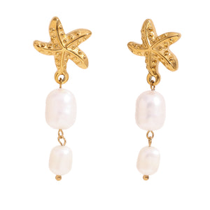 Gold starfish earrings with pearl drops on a white background