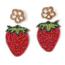 Load image into Gallery viewer, Woman sitting on grass accessorized with a pink embellished strawberry headband and vibrant handcrafted strawberry earrings.