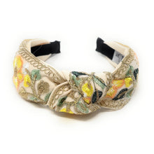 Load image into Gallery viewer, Elegant fabric headband with colorful floral embroidery in yellow, orange, and green. Features a delicate bow. Tag inside reads "True and Love."