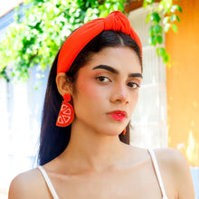 Load image into Gallery viewer, Chic summer accessory look with a vivid orange knot headband and colorful citrus drop earrings.