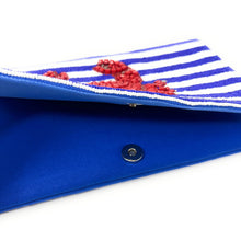 Load image into Gallery viewer, Summer fashion accessory showcasing a striped beaded clutch with detailed red crab embroidery and bead accents.