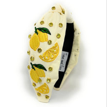 Load image into Gallery viewer, Woman in a green halter top accessorized with a white citrus-themed headband and yellow beaded lemon earrings.