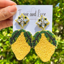 Load image into Gallery viewer, Tropical lemon drop earrings with yellow bead embroidery, green leaf accents, and sparkling crystal tops.