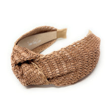 Load image into Gallery viewer, A woven straw twist headband in a natural tan color, displayed on a clean white background. The brand name 'Twine and Love' is visible on the inner paper label.