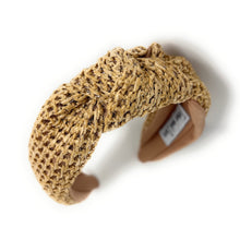 Load image into Gallery viewer, A woven straw headband featuring a twisted knot design, with a soft beige lining. The label inside reads &quot;Time and Love,&quot; set against a white background.