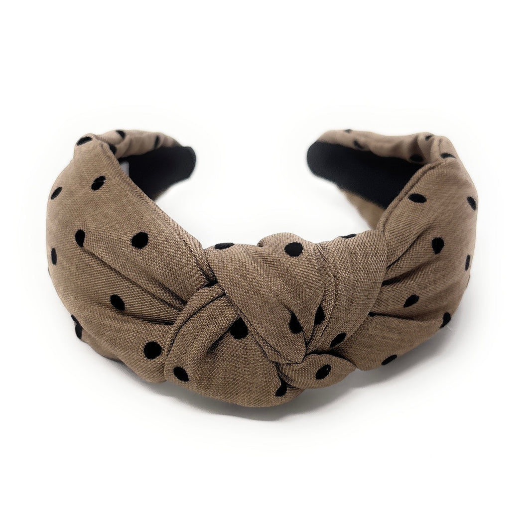 tan headband with black polka dots on a white background
