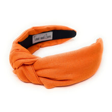 Load image into Gallery viewer, Chic pumpkin-orange headband with a gathered knot accent, modeled outdoors in natural sunlight.