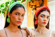 Load image into Gallery viewer, Trendy tropical-inspired outfit featuring an orange statement headband and matching fruit-themed earrings.