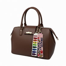 Load image into Gallery viewer, Brown handbag with colorful keychain on a white background
