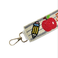 Load image into Gallery viewer, Beaded keychain with pencil and apple design on a white background