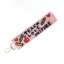 Load image into Gallery viewer, Pink keychain with 'Teach Love Inspire' text and educational symbols on a white background