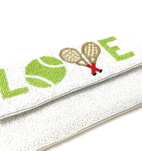 Load image into Gallery viewer, Hand-beaded tennis-themed envelope clutch featuring a vibrant tennis ball, crossed rackets, and “LOVE” lettering on a white beaded background.