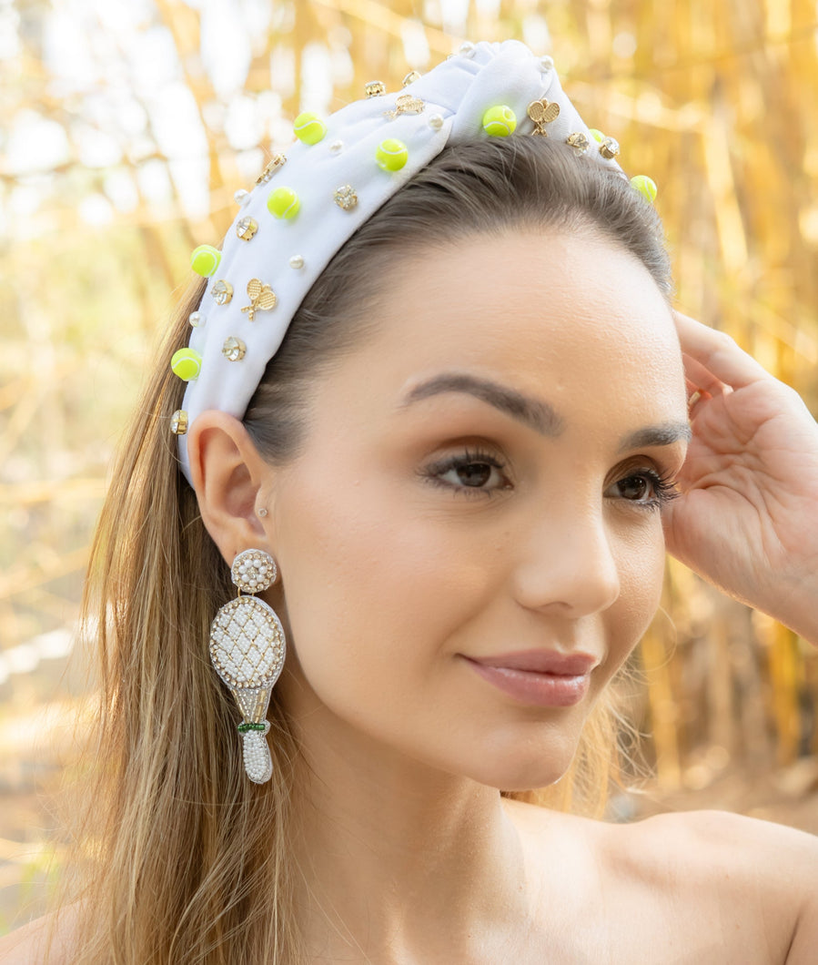 Woman wearing a decorative headband and beautiful jeweled tennis earrings