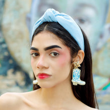 Load image into Gallery viewer, Statement cowboy boot earrings with turquoise accents worn by a model, creating a fun blend of western charm and modern fashion.