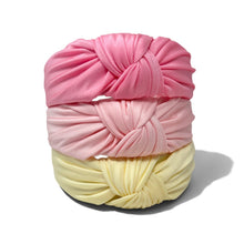 Load image into Gallery viewer, Three knotted fabric headwraps stacked vertically on a white background, in pink, light pink, and pale yellow.